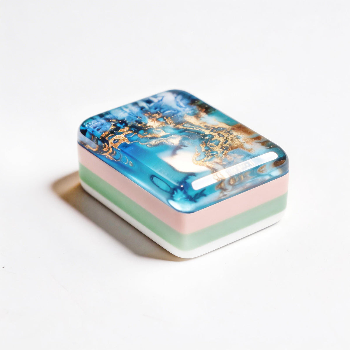 	Angled view of ocean mahjong tile showing marbled blue resin and striped sides